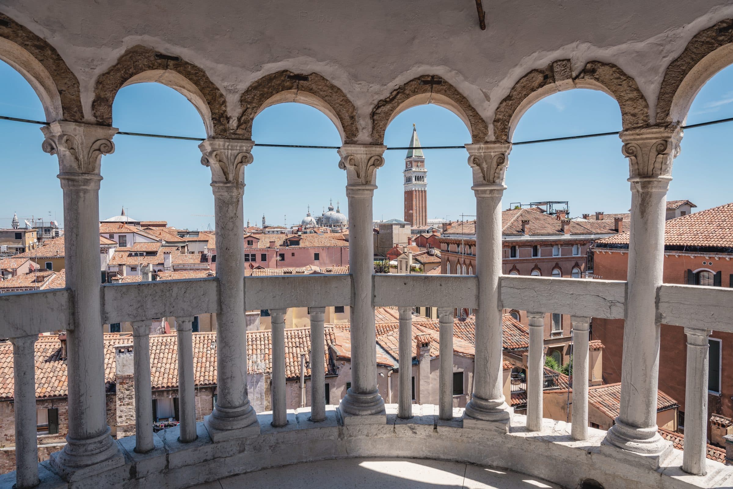 Venice rooftops seen through the arches of the Contarini del Bovolo staircase