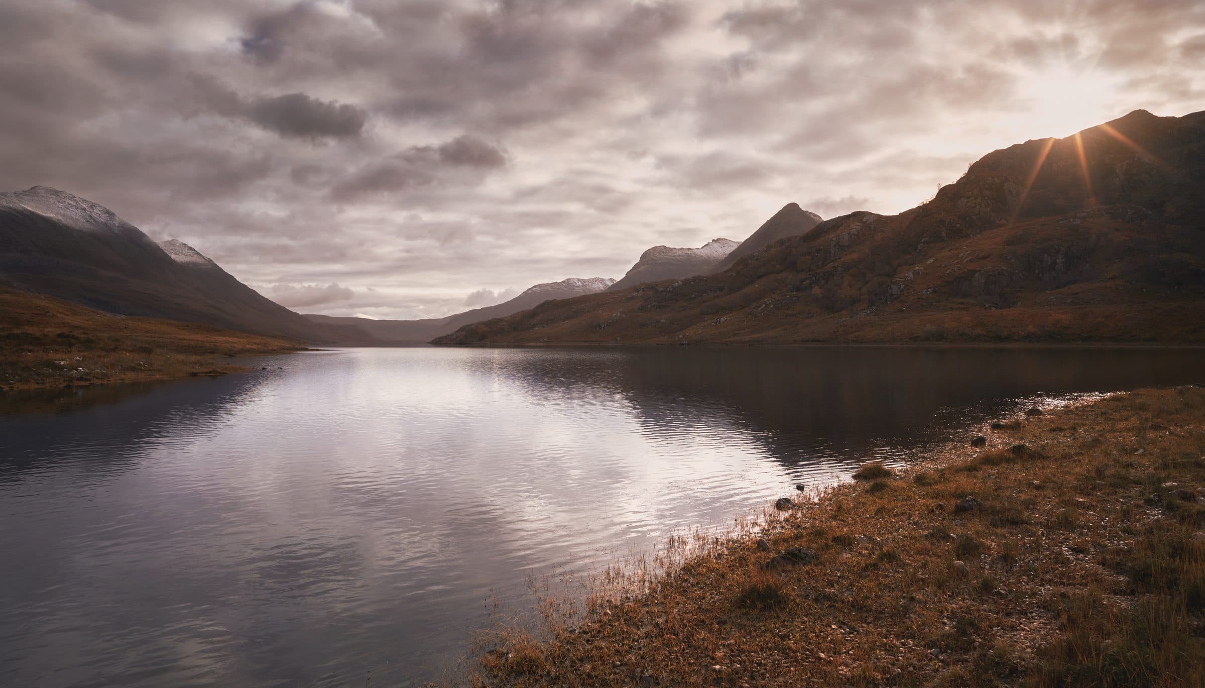 A still loch below the hills of Wester Ross at dusk